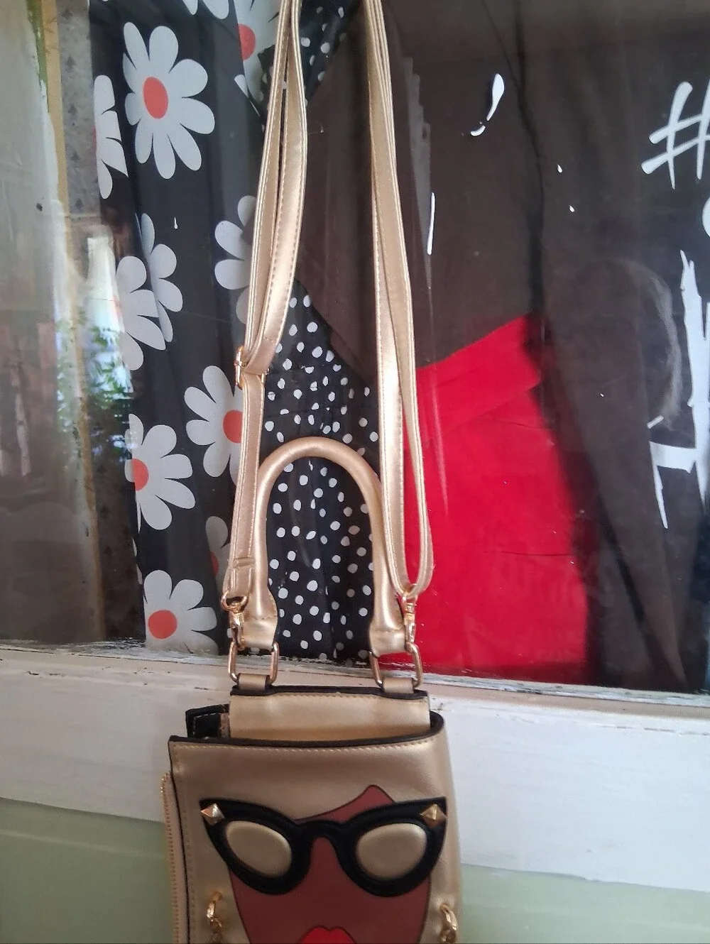 Fashionable Gold Crossbody Bag with Graphic Face Design